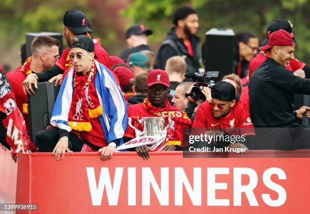 Sadio Mane of Liverpool holds the Carabao Cup Trophy alongside teammates during the Liverpool Trophy Parade on May 29, 2022 in Liverpool, England.