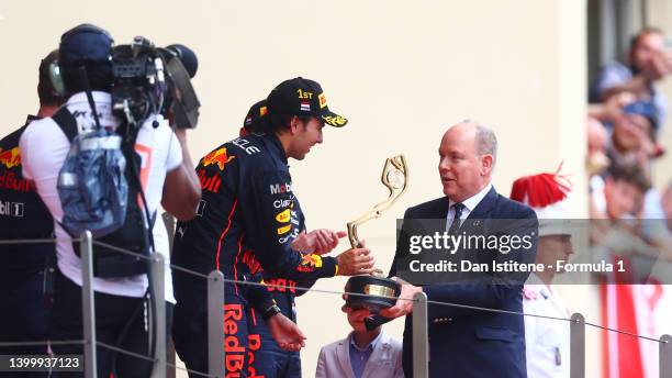 Race winner Sergio Perez of Mexico and Oracle Red Bull Racing is presented with his trophy by Prince Albert of Monaco during the F1 Grand Prix of...