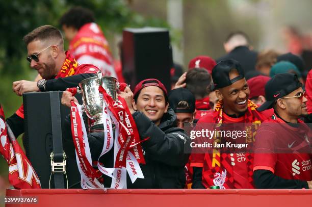 Takumi Minamino of Liverpool celebrates with the Carabao Cup Trophy during the Liverpool Trophy Parade on May 29, 2022 in Liverpool, England.