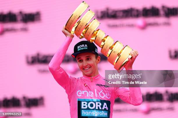 Jai Hindley of Australia and Team Bora - Hansgrohe Pink Leader Jersey celebrates at podium with the Trofeo Senza Fine as overall race winner during...