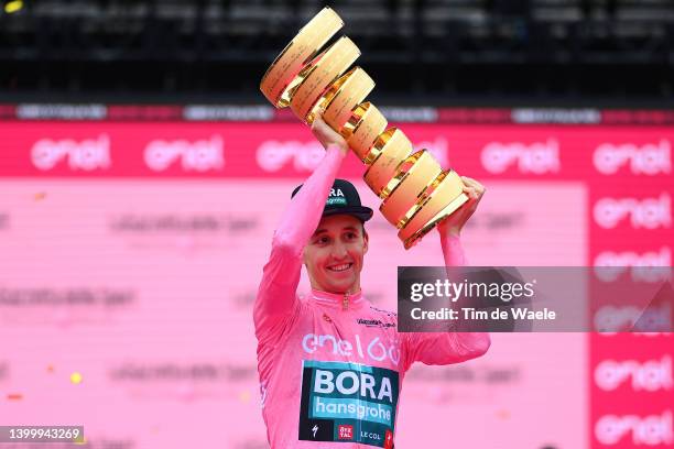 Jai Hindley of Australia and Team Bora - Hansgrohe Pink Leader Jersey celebrates at podium with the Trofeo Senza Fine as overall race winner during...