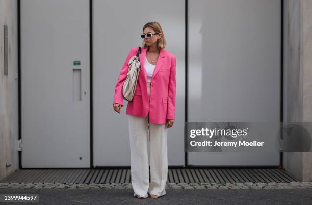 Aline Kaplan is seen wearing Carolina Lemke shades, Nanushka bag, Zara pink blazer, a white top and Zara beige linen pants on May 25, 2022 in Berlin,...