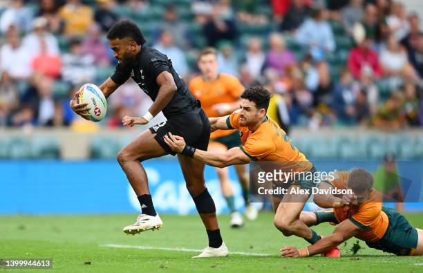 Akuila Rokolisoa of New Zealand breaks through Matthew Gonzalez of Australia on the way to scoring a try during the Final between New Zealand and...