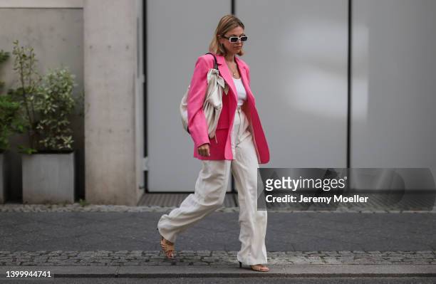 Aline Kaplan is seen wearing Carolina Lemke shades, Nanushka bag, Zara pink blazer, a white top and Zara beige linen pants on May 25, 2022 in Berlin,...