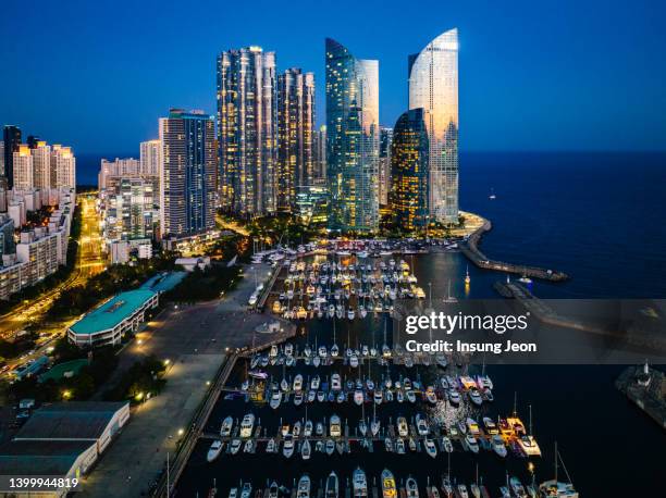 aerial view of boats moored in marina at night - busan stock pictures, royalty-free photos & images