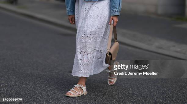 Aline Kaplan is seen wearing a Mango jeans jacket, French Connection white dress, Ray Ban shades, Agneel beige bag and Chanel white sandals on May...