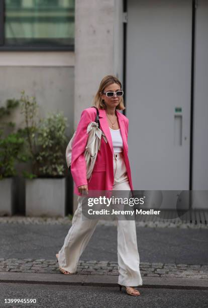 Aline Kaplan is seen wearing Carolina Lemke shades, Nanushka bag, Zara pink blazer, a white top and Zara beige linen pants on May 25, 2022 in Berlin,...