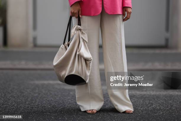 Aline Kaplan is seen wearing Nanushka bag, Gucci shoes, Zara pink blazer and Zara beige linen pants on May 25, 2022 in Berlin, Germany.