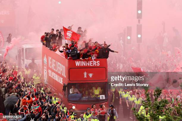 Kostas Tsimikas, Diogo Jota, Curtis Jones, Fabinho, Roberto Firmino and Thiago Alcantara of Liverpool celebrate on the team bus during the Liverpool...