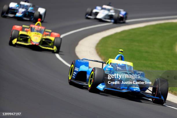Jimmie Johnson, driver of the Carvana Chip Ganassi Racing Honda, leads a pack of cars during the 106th running of the Indianapolis 500 at...