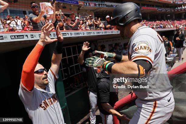 Curt Casali and Evan Longoria of the San Francisco Giants celebrate after Longoria hit a home run in the eighth inning against the Cincinnati Reds at...