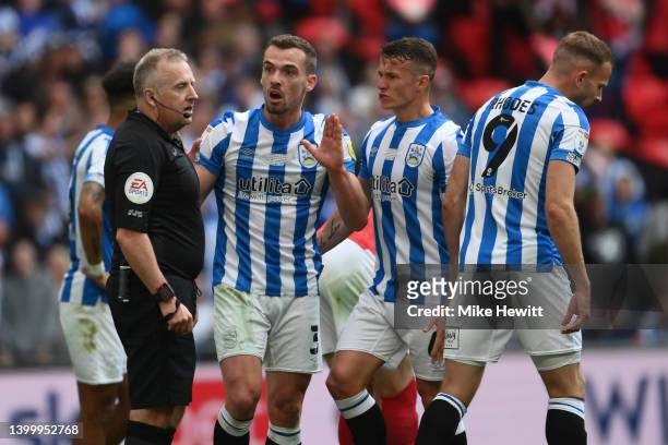 Harry Toffolo of Huddersfield remonstrates with referee Jon Moss after being booked for diving during the Sky Bet Championship Play-Off Final match...
