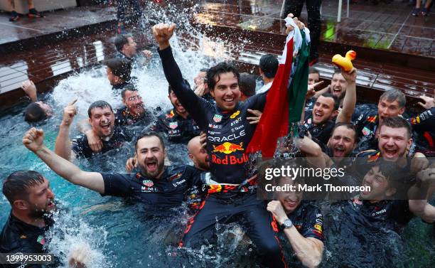 Race winner Sergio Perez of Mexico and Oracle Red Bull Racing celebrates with his team by jumping into the pool after the F1 Grand Prix of Monaco at...