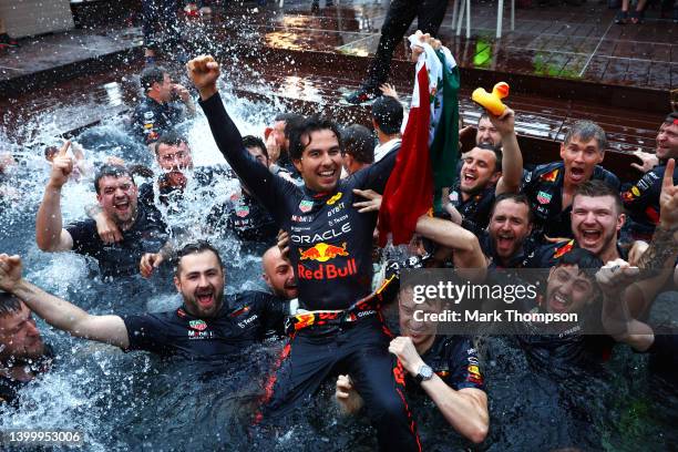 Race winner Sergio Perez of Mexico and Oracle Red Bull Racing celebrates with his team by jumping into the pool after the F1 Grand Prix of Monaco at...