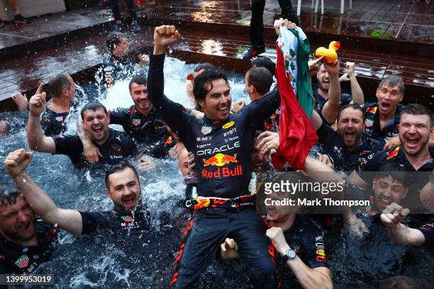Race winner Sergio Perez of Mexico and Oracle Red Bull Racing celebrates with his team by jumping into the pool after the F1 Grand Prix of Monaco at...