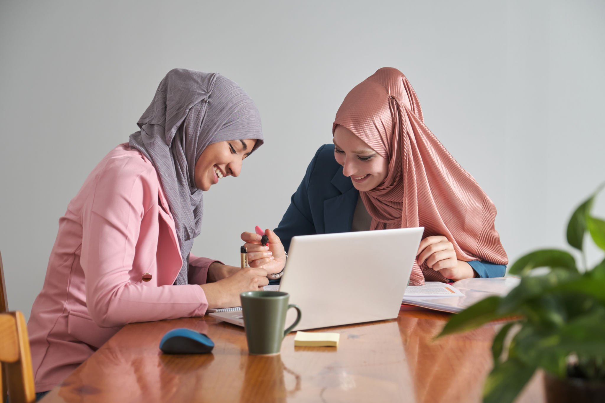 Two muslim female university students wearing hijab studying after class. Two muslim female university students wearing hijab studying after class.