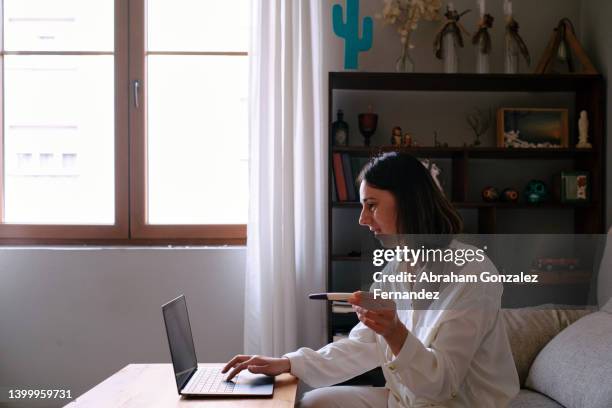 woman looking at the computer for pregnancy test instructions. - ovulation stock pictures, royalty-free photos & images