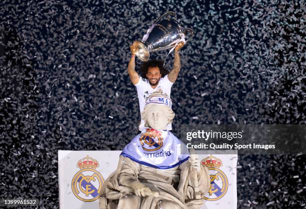 Marcelo Vieira of Real Madrid holds the UEFA Champions League trophy during the UEFA Champions League trophy bus parade after winning the UEFA...