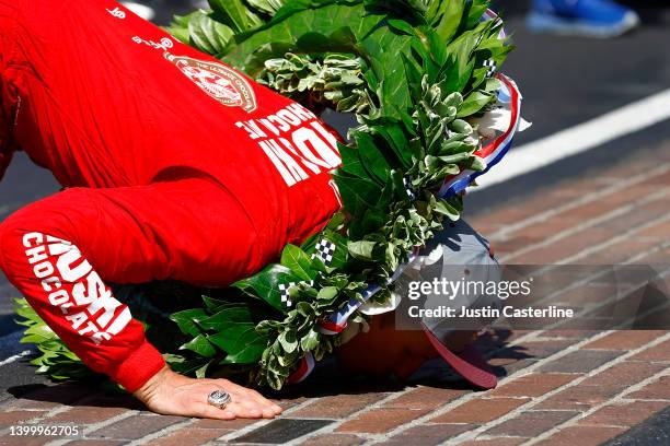 Marcus Ericsson of Sweden, driver of the Chip Ganassi Racing Honda, kisses the bricks after winning the 106th Running of The Indianapolis 500 at...