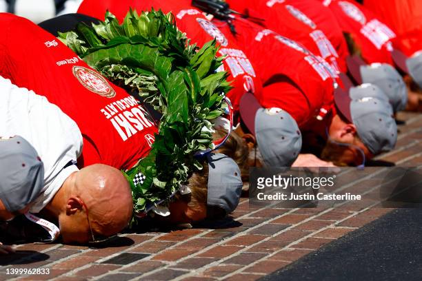 Marcus Ericsson of Sweden, driver of the Chip Ganassi Racing Honda, and his team kiss the bricks after winning the 106th Running of The Indianapolis...