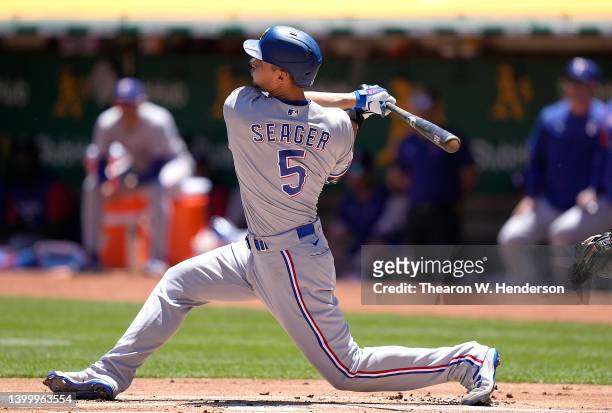 Corey Seager of the Texas Rangers hits a solo home run against the Oakland Athletics in the top of the first inning at RingCentral Coliseum on May...