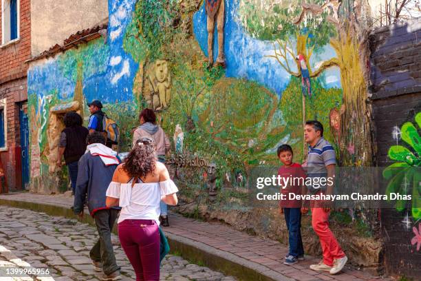 bogotá, colombia - local colombians on the cobblestoned calle del embudo, in the historic la candelaria district of the south american andes capital city - embudo stock pictures, royalty-free photos & images