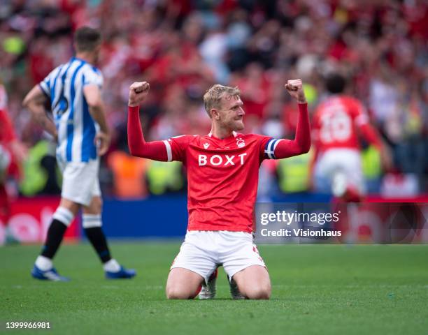 Joe Worrall of Nottingham Forest celebrates with Jonathan Hogg of Huddersfield Town looking dejected behind following the Sky Bet Championship...