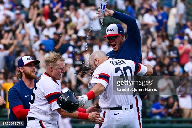 Jake Burger of the Chicago White Sox gets doused with water after his game-winning single in the 12th inning against the Chicago Cubs at Guaranteed...