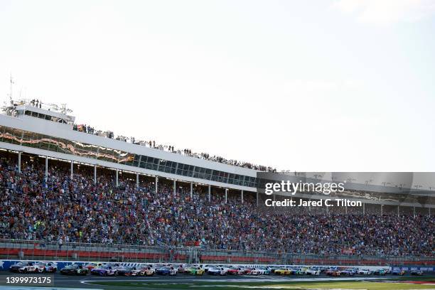 Denny Hamlin, driver of the FedEx Ground Toyota, leads the field to start the NASCAR Cup Series Coca-Cola 600 at Charlotte Motor Speedway on May 29,...