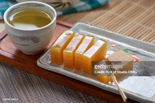 yokan served with a cup of green tea - 羊羹 ストックフォトと画像