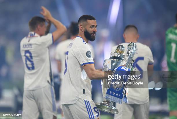 Karim Benzema of Real Madrid holds the trophy during celebrations at estadio Santiago Bernabeu after winning the UEFA Champions League Final on May...
