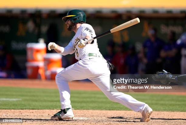 Jed Lowrie of the Oakland Athletics hits a walk-off RBI single scoring Cristian Pache in the bottom of the ninth inning to defeat the Texas Rangers...