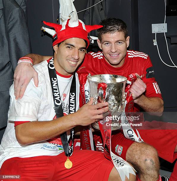 Luis Suarez and Steven Gerrard of Liverpool celebrate with the trophy at the end of the Carling Cup Final match between Liverpool and Cardiff City at...
