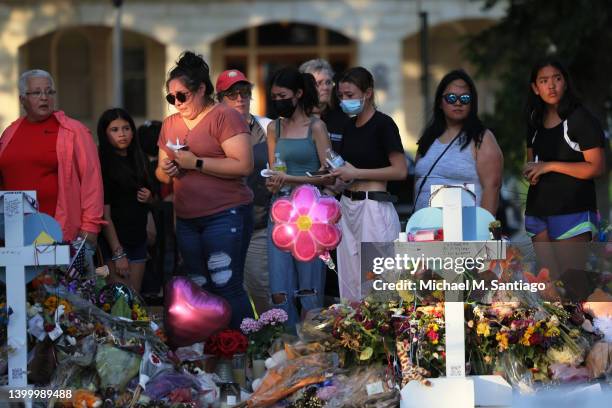 People visit a memorial for the victims of the Robb Elementary School mass shooting at the City of Uvalde Town Square on May 29, 2022 in Uvalde,...