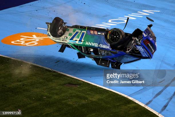 Chris Buescher, driver of the Fifth Third Bank Ford, flips into the infield grass after an on-track incident during the NASCAR Cup Series Coca-Cola...