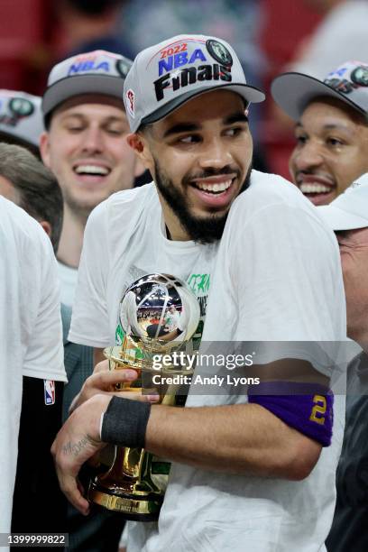 Jayson Tatum of the Boston Celtics celebrates after being awarded the Eastern Conference Larry Bird MVP trophy after defeating the Miami Heat in Game...