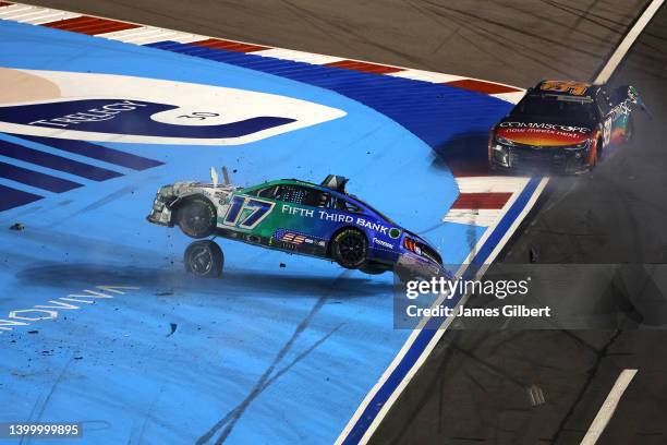 Chris Buescher, driver of the Fifth Third Bank Ford, flips after an on-track incident with Daniel Suarez, driver of the CommScope Chevrolet, during...