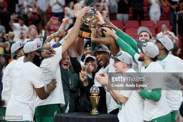 Al Horford of the Boston Celtics celebrates with his teammates and the Eastern Conference Bob Cousy champions trophy after defeating the Miami Heat...