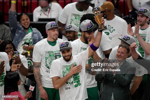 Jayson Tatum of the Boston Celtics celebrates after being awarded the Eastern Conference Larry Bird MVP trophy after defeating the Miami Heat in Game...