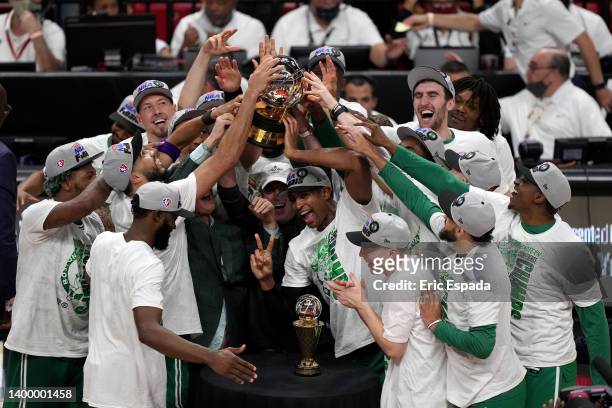Al Horford of the Boston Celtics celebrates with his teammates and the Eastern Conference Bob Cousy champions trophy after defeating the Miami Heat...