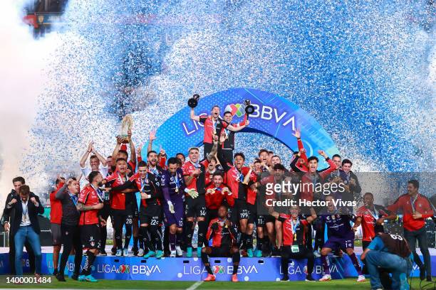Martin Nervo and Aldo Rocha of Atlas lift the Campeon de Campeones and Liga MX champion's trophies after winning the final second leg match between...