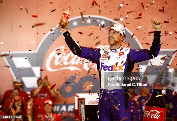 Denny Hamlin, driver of the FedEx Ground Toyota, celebrates in victory lane after winning the NASCAR Cup Series Coca-Cola 600 at Charlotte Motor...