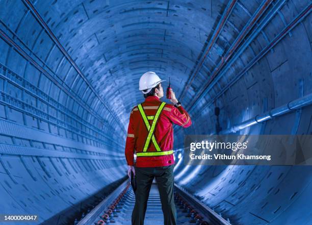 tunnel engineer in dark railway tunnel construction site - automotive technician stockfoto's en -beelden