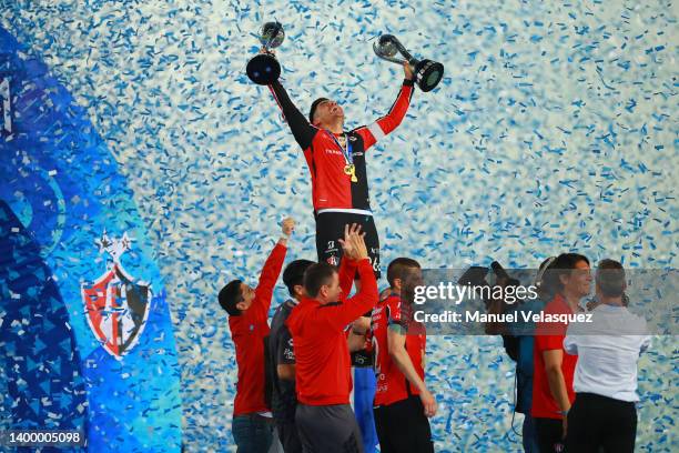 Aldo Rocha of Atlas lifts the Campeon de Campeones and Liga MX champion's trohphies after the final second leg match between Pachuca and Atlas as...