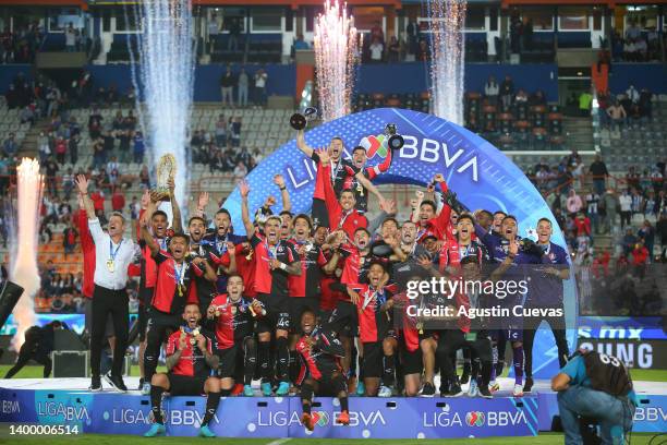 Martin Nervo and Aldo Rocha of Atlas lift the Campeon de Campeones and Liga MX champion's trophies after the final second leg match between Pachuca...