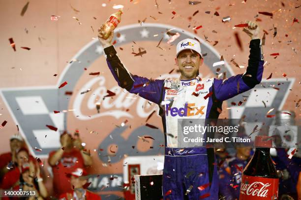 Denny Hamlin, driver of the FedEx Ground Toyota, celebrates in Victory Lane after winning the NASCAR Cup Series Coca-Cola 600 at Charlotte Motor...