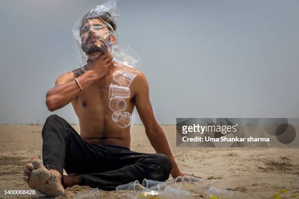 face of a man covered with polythene bag, disposal glasses thrown around. - choking stock pictures, royalty-free photos & images