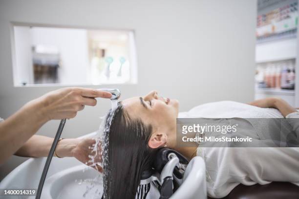 hair wash in a hair salon - hair conditioner stockfoto's en -beelden