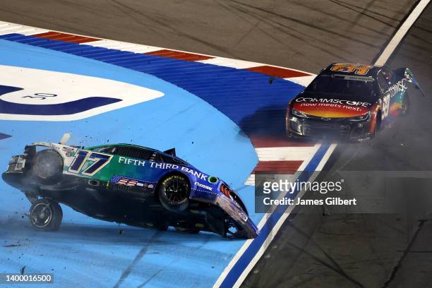 Chris Buescher, driver of the Fifth Third Bank Ford, flips after an on-track incident with Daniel Suarez, driver of the CommScope Chevrolet, during...