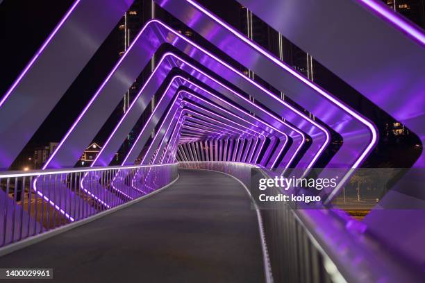 pedestrian bridge neon light effect - illuminated bridge stock pictures, royalty-free photos & images